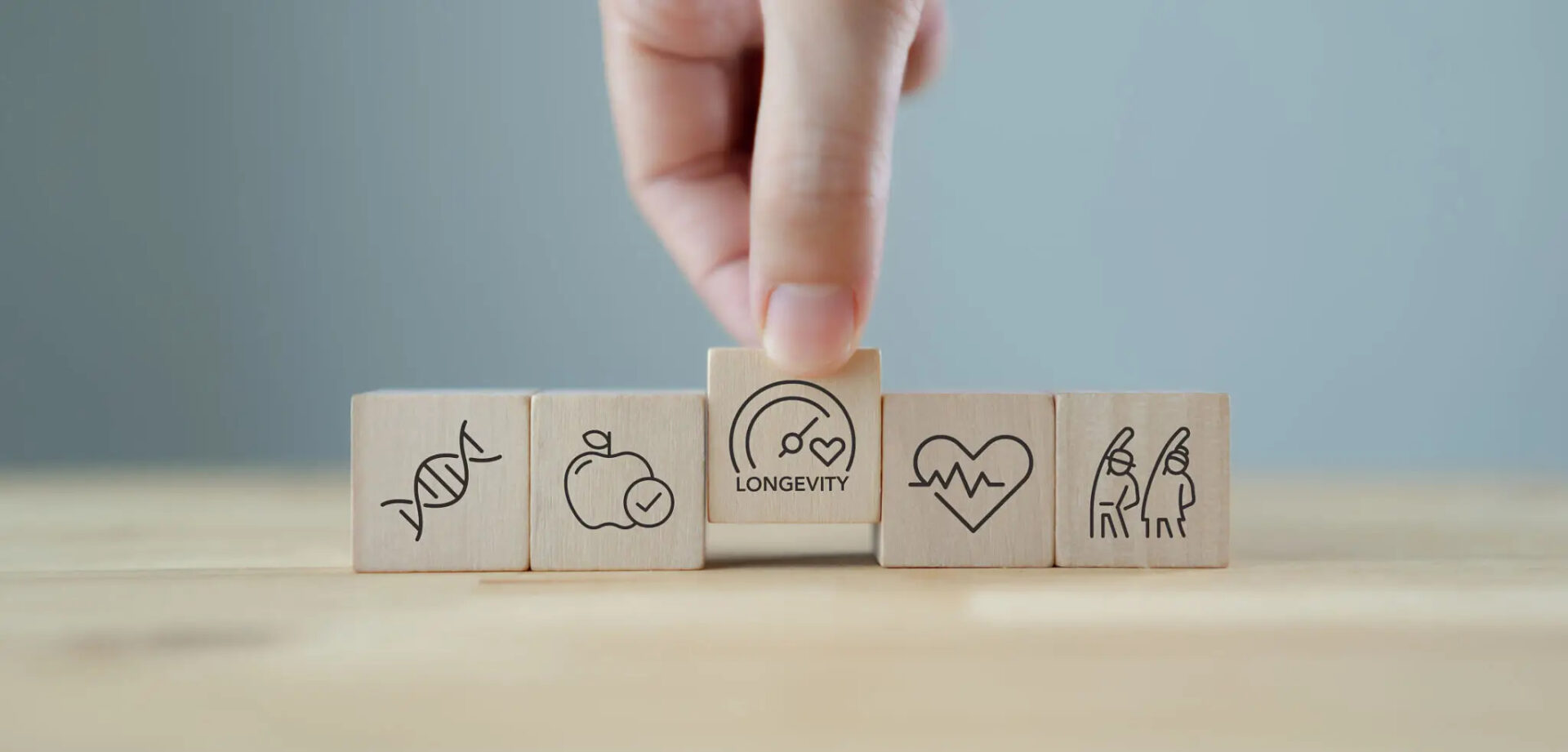 Hand placing a wooden block with a community icon among health-related blocks.