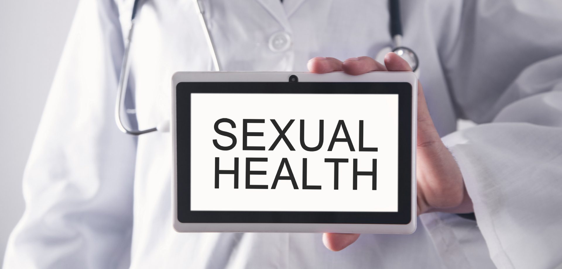 Tablet displaying the words 'SEXUAL HEALTH' in bold letters.