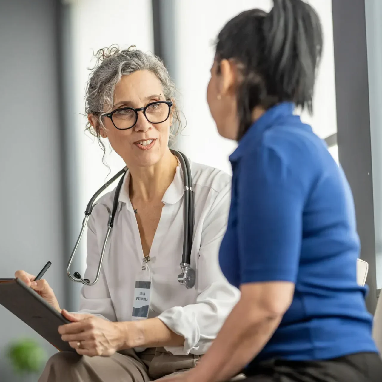 Doctor attentively listening to a patient during consultation.